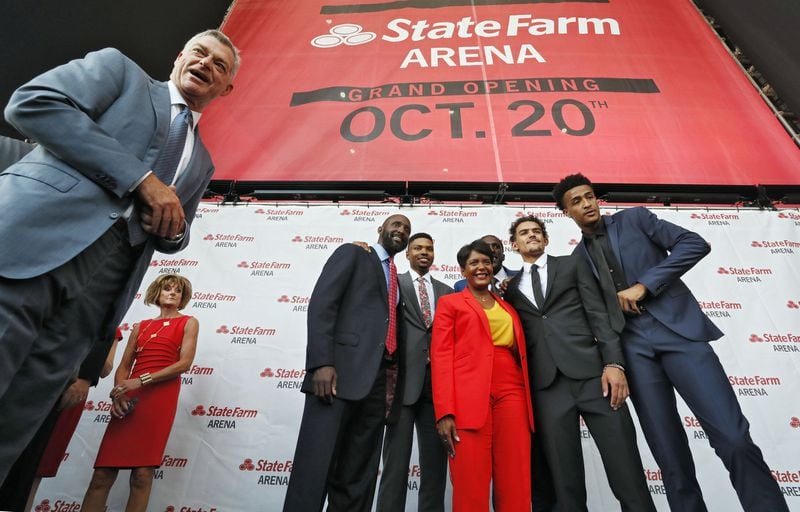 8/29/18 - Atlanta - Tony Ressler (left), Atlanta Hawks Principal Owner, Atlanta Mayor Keisha Lance Bottoms, and members of the Hawks have photos taken in front of the banner with the new name. The Atlanta Hawks and State Farm today announced the naming of the new State Farm Arena, formerly Philips Arena. State Farm Arena, the new home of the Hawks, will open its doors following the completion of the $192.5 million-dollar renovation. BOB ANDRES /BANDRES@AJC.COM