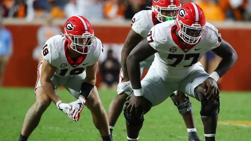 Georgia tight end Brock Bowers and offensive lineman Junior Amarius Mims prepare to block against Tennessee on Saturday, Nov. 18, 2023, in Knoxville. Curtis Compton for the Atlanta Journal Constitution