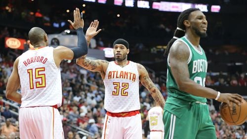 Hawks’ Mike Scott (center) is congratulated by Al Horford during Game 5 of an NBA basketball first-round playoff series at Philips Arena on Tuesday, April 26, 2016, in Atlanta. Curtis Compton / ccompton@ajc.com