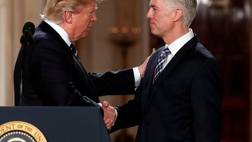 President Donald Trump shakes hands with 10th U.S. Circuit Court of Appeals Judge Neil Gorsuch, his choice for Supreme Court associate justice in the East Room of the White House in Washington, Tuesday, Jan. 31, 2017. (AP Photo/Carolyn Kaster)