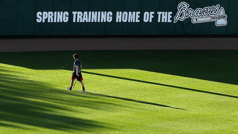 Baseball pennants in the outfield cast large shadows across the field at Champion Stadium as Braves top prospect Dansby Swanson makes an early morning walk to the batting cages to begin his day of spring training on Thursday, Feb 25, 2016, at the ESPN Wide World of Sports, Lake Buena Vista, Fla.