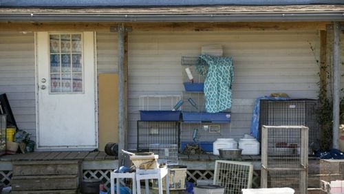 Animal cages are stacked on the porch of a house on Misty Drive in Uhland on Tuesday, February 21, 2017, where on Monday more than 400 live animals were seized by the Caldwell County sheriff's office with the help of the SPCA of Texas. (Jay Janner/Austin American-Statesman)