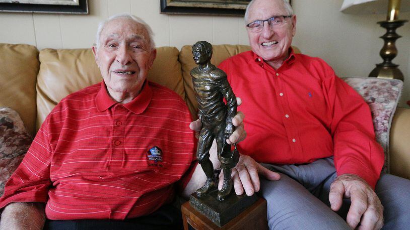 Georgia legends Charley Trippi, 96, with his Rose Bowl Hall of Fame trophy, and Vince Dooley, 85, share a laugh at the Trippi home on Thursday, Dec. 21, 2017, in Athens.