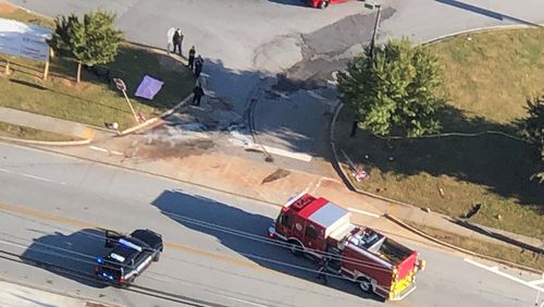 DeKalb County police and firefighters investigated the fatal crash at the entrance to Lakeside High School's upper parking lot.