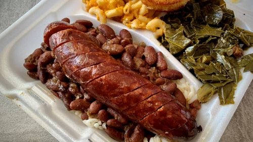 This serving of red beans and rice with smoked sausage from Daddy D’z includes collard greens and macaroni and cheese on the side. Henri Hollis/henri.hollis@ajc.com