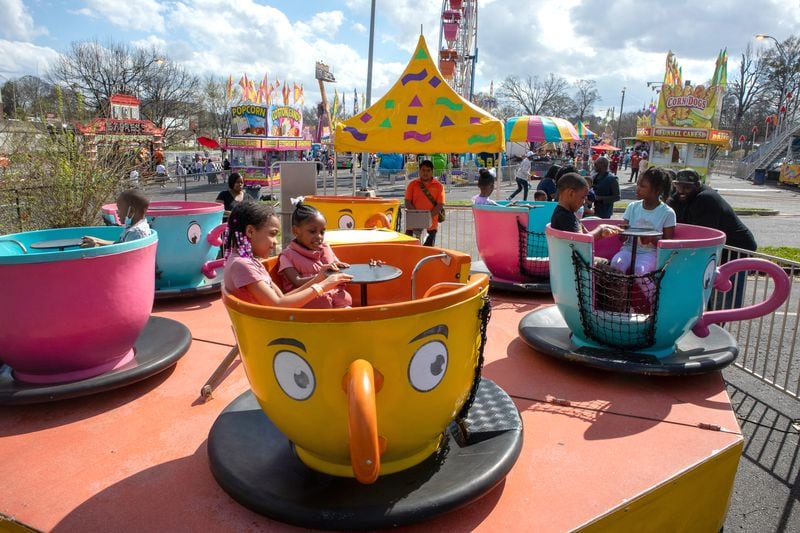 Kids ride in teacups at the Atlanta Fair on Sunday, March 6, 2022. This was the opening weekend for the annual fair that runs through April 10. (Photo by Steve Schaefer for The Atlanta Journal-Constitution)