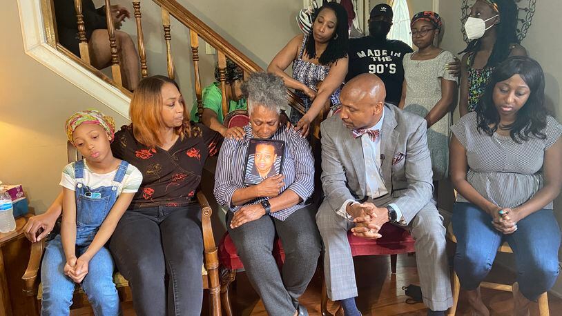 Matthew Williams' mother holds his photo as she is consoled by family members in her living room. Williams was killed during an encounter with police earlier this month at his DeKalb County condo. (Photo: Shaddi Abusaid / shaddi.abusaid@ajc.com)