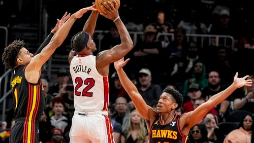 Miami Heat forward Jimmy Butler (22) shoots against Atlanta Hawks forward De'Andre Hunter (12) during the first half of an NBA basketball game, Tuesday, April 9, 2024, in Atlanta. Miami won 117-111 in two overtimes. (AP Photo/Mike Stewart)