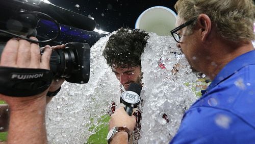 Dansby Swanson gets the congratulatory ice shower after his walk-off single gave the Braves a 5-4 win over the Padres Monday.