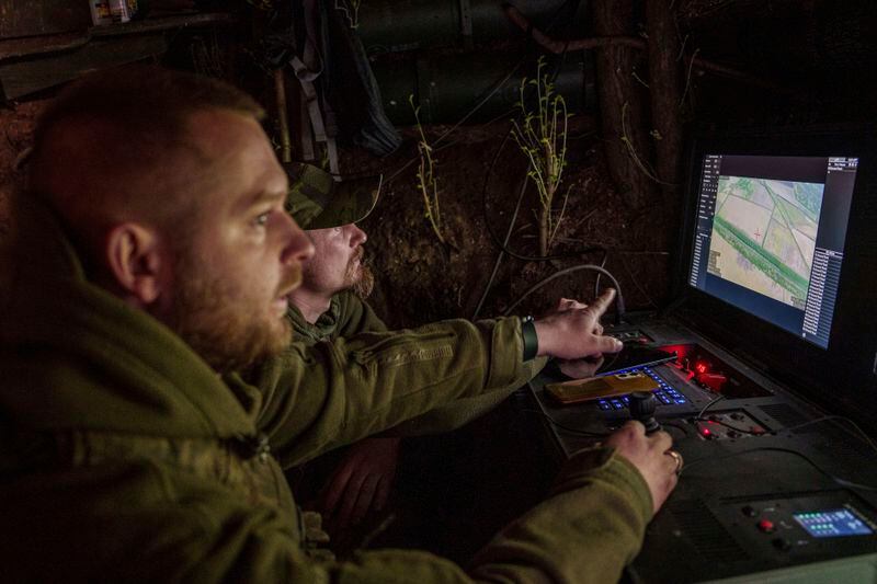 Ukrainian servicemen Anatolii and Dmytro of 148th separate artillery brigade of the Air Assault Forces correct fire during flight over Russian positions by a Furia drone at the frontline in Donetsk region, Ukraine, Thursday May 9, 2024. (AP Photo/Evgeniy Maloletka)