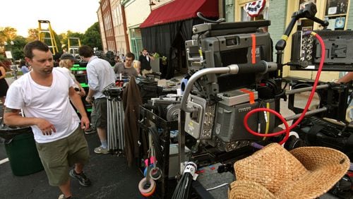 Camera assistant Grady Upchurch of Marietta walks to his area where he prepares a camera during filming for &ldquo;Drop Dead Diva,&rdquo; a Lifetime television series, in a retail shop along Main Street in downtown Senoia in 2010. Georgia offers one of the country&rsquo;s most generous film and TV production tax incentive schemes, having doled out more than $1 billion in credits over the past decade in order to attract studios to the state. Jason Getz jgetz@ajc.com