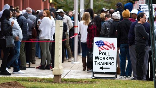 People wait in a long line to vote Saturday at the Cobb County Board of Elections and Registration Office in Marietta. STEVE SCHAEFER / SPECIAL TO THE AJC