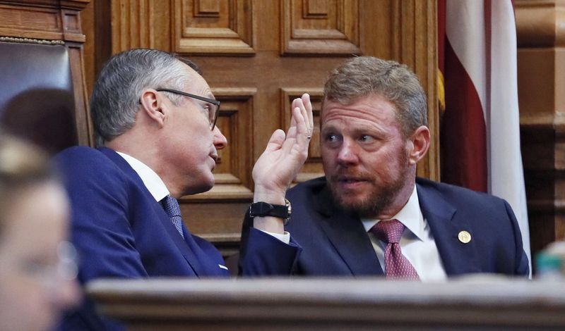 Lt. Gov. Casey Cagle and Chris Riley, Gov. Nathan Deal's chief of staff, confer in the Senate on the Delta/NRA flap. BOB ANDRES /BANDRES@AJC.COM