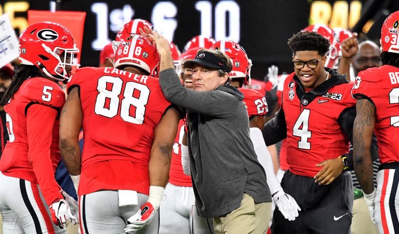 Georgia Bulldogs head coach Kirby Smart congratulates his players as captain and defensive end Nolan Smith (4) reacts during the second half of the College Football Playoff National Championship at SoFi Stadium in Los Angeles on Monday, January 9, 2023. Georgia won 65-7 and secured a back-to-back championship. (Hyosub Shin / Hyosub.Shin@ajc.com)