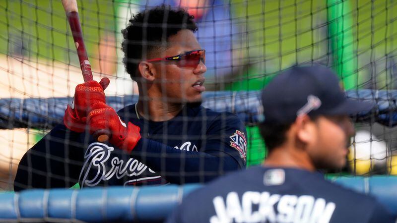 Atlanta Braves catcher William Contreras takes batting practice as fellow catcher Alex Jackson (foreground) looks on before a spring training game Monday, March 29, 2021, against the Boston Red Sox at CoolToday Park in North Port, Fla. (John Bazemore/AP)
