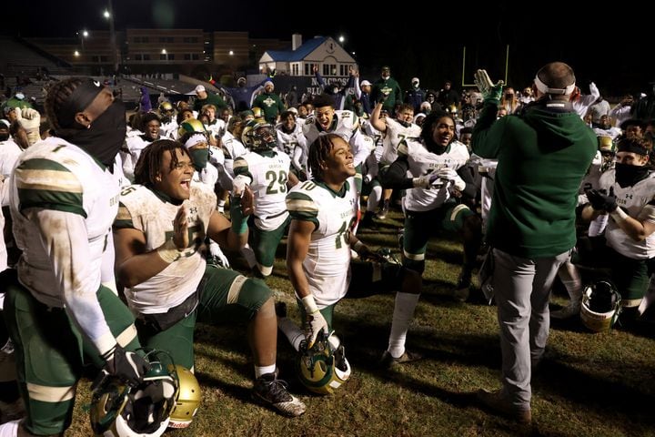 Dec. 18, 2020 - Norcross, Ga: Grayson coach Adam Carter, right, celebrates with players after their 28-0 win against Norcross in the Class AAAAAAA semi-final game at Norcross high school Friday, December 18, 2020 in Norcross, Ga.. Grayson advances to play in the Class AAAAAAA final. JASON GETZ FOR THE ATLANTA JOURNAL-CONSTITUTION