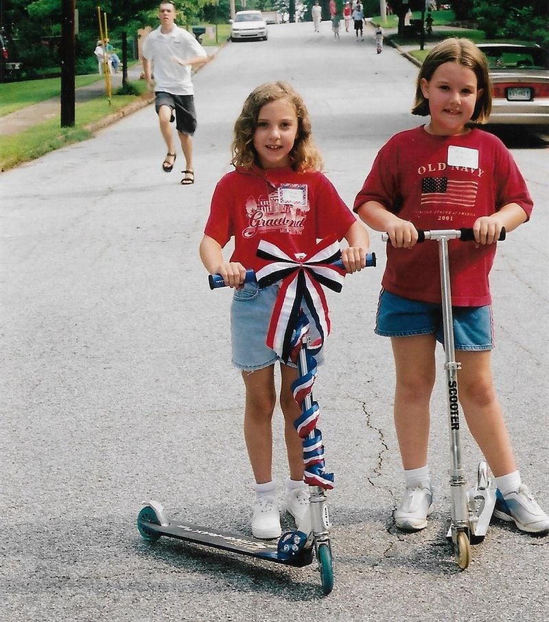Olivia King (left) and friend Emily Falco prepare to participate in the 2002 Fourth of July parade on the streets of the Pine Glen neighborhood in DeKalb County. CONTRIBUTED BY THE KING FAMILY