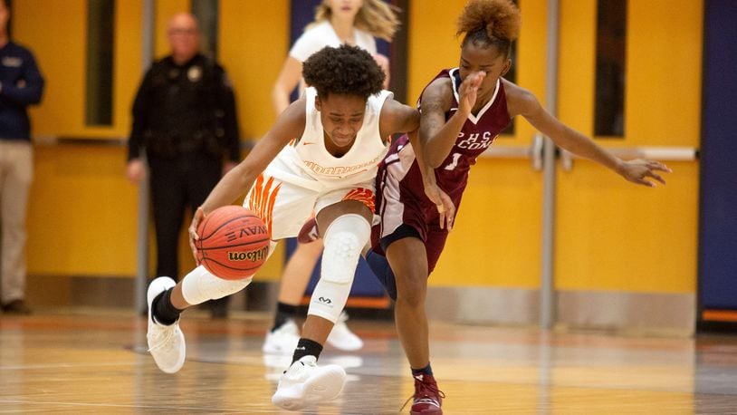 North Cobb High School girls basketball player Dayuna Colin drives past  Pebblebrook High School player Jalicia Bass during the first round of the girls' high school basketball tournament at North Cobb High School in Kennesaw February 15, 2018. STEVE SCHAEFER / SPECIAL TO THE AJC