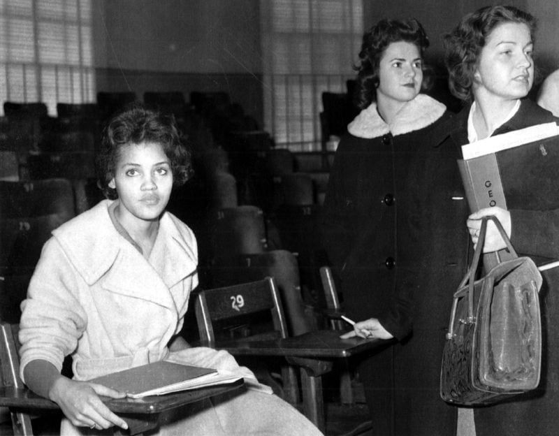 Charlayne Hunter, left, prepares to leave one of her classes at the University of Georgia on Jan. 11, 1961. (AJC file)