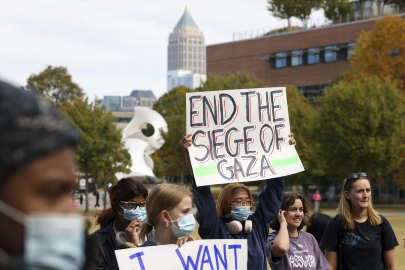A student demonstrator holds a sign, “End the Siege of Gaza,” during a rally in support of Palestinian, Arab and Muslim students on the Tech Green on the Georgia Tech campus, Wednesday, Oct. 25, 2023, in Atlanta. (Jason Getz / Jason.Getz@ajc.com)