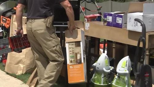 The GBI confiscated dozens of items from the home of a former supervisor accused of illegally using her purchasing card.