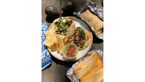 A takeout spread from Bell Street Burritos includes a grilled pork and green chili burrito; a chicken and a pork tamale; guacamole and chips; and a shrimp and a ground beef taco. You may also buy ingredients like avocados from the online market. CONTRIBUTED BY WENDELL BROCK