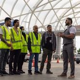 Mirwais Jalali (right), a recruiter for aviation contractor Unifi, prepares to give new employees a tour of the Hartsfield-Jackson airport in Atlanta on Friday, April 19, 2024. (Arvin Temkar / arvin.temkar@ajc.com)