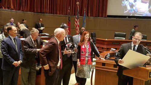 Fulton County Commission Chairman John Eaves reads a proclamation about Atlanta Falcons Rise Up Day to Falcons General Manager Rich McKay and members of the Board of Commissioners. ARIELLE KASS/AKASS@AJC.COM