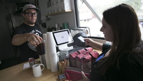 Rebecca Liebman, founder of a financial literacy site for millennials called LearnLux, pays for an iced coffee with her discover credit card at Triangle coffee in Boston, Aug. 12, 2016. Building a credit history holds less appeal for young Americans who had trouble paying off student loans and saw their families’ struggles during the financial crisis. (Katherine Taylor/The New York Times)