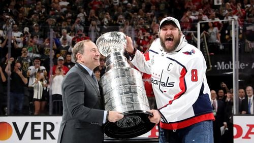 Alex Ovechkin #8 of the Washington Capitals is presented the Stanley Cup by NHL Commissioner Gary Bettman after his team defeated the Vegas Golden Knights 4-3 in Game Five of the 2018 NHL Stanley Cup Final at T-Mobile Arena on June 7, 2018 in Las Vegas, Nevada.  (Photo by Bruce Bennett/Getty Images)