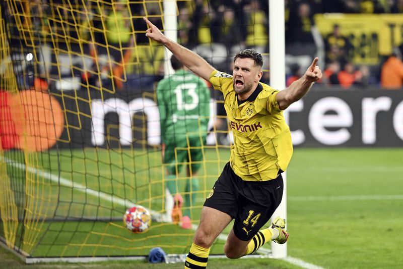 Dortmund's Niclas Fuellkrug celebrates after scoring his side's third goal during the Champions League quarterfinal second-leg soccer match between Borussia Dortmund and Atletico Madrid at the Signal-Iduna Park in Dortmund, Germany, Tuesday, April 16, 2024. (Bernd Thissen/dpa via AP)