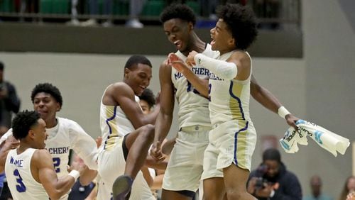 McEachern guard Sharife Cooper (2, right) celebrates with teammates advancing to the Class AAAAAAA state basketball championship with a win over Norcross Saturday, March 2, 2019 in Buford.