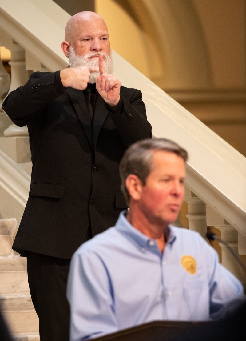 David Cowan translates as Gov. Brian Kemp answers a journalist’s question during a press conference on April 8, 2020. 