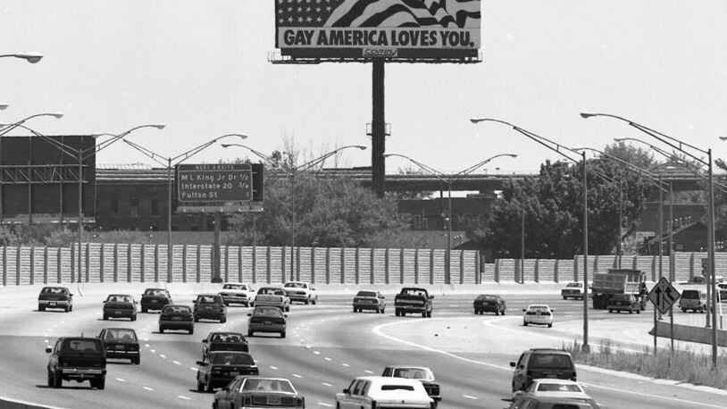 A billboard "Gay America Loves You," billboard, looking south down the Downtown Connector, Atlanta, Georgia, June 20, 1990. PHOTO BY WILLIAM BERRY / AJC ARCHIVES