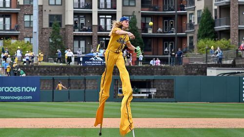 Savannah Bananas' Dakota Albritton, using stilts, throws a pitch during the game against the Party Animals at Coolray Field. The Savannah Bananas’ visit is their first to the Atlanta area since their founding in 2016. The team is based in their namesake Georgia city and plays 30-plus games a year at Historic Grayson Stadium, a century-old ballpark on Savannah’s eastside.  (Hyosub Shin / Hyosub.Shin@ajc.com)