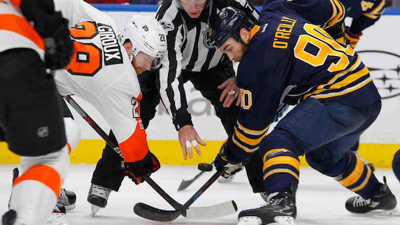 Buffalo Sabres Ryan O'Reilly (90) and Philadelphia Flyers Claude Giroux (28) battle for the puck during the second period of an NHL hockey game, Tuesday, Jan. 10, 2017, in Buffalo, N.Y. (AP Photo/Jeffrey T. Barnes)