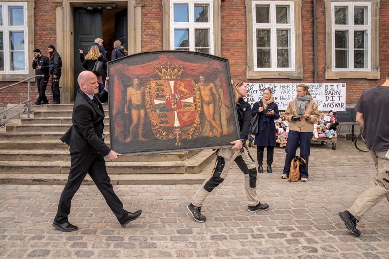 Historical paintings are carried out of the burning building as the Stock Exchange burns in Copenhagen, Denmark, Tuesday, April 16, 2024. A fire raged through one of Copenhagen’s oldest buildings on Tuesday, causing the collapse of the iconic spire of the 17th-century Old Stock Exchange as passersby rushed to help emergency services save priceless paintings and other valuables. (Ida Marie Odgaard/Ritzau Scanpix via AP)