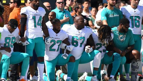 Some of the Miami Dolphins take a knee during the anthem prior to the game against the New York Jets last season.