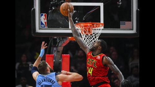 Hawks free agent center Dewayne Dedmon (right) reportedly has agreed to a contract with the Kings.