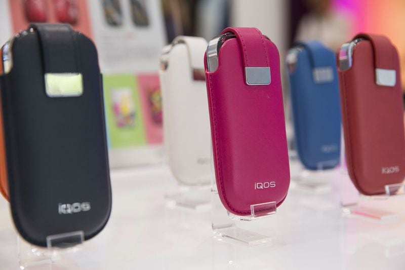 Sleak and colorful cases for the smokeless device are displayed for sale at IQOS store in Tokyo. Photo for The Washington Post by Shiho Fukada