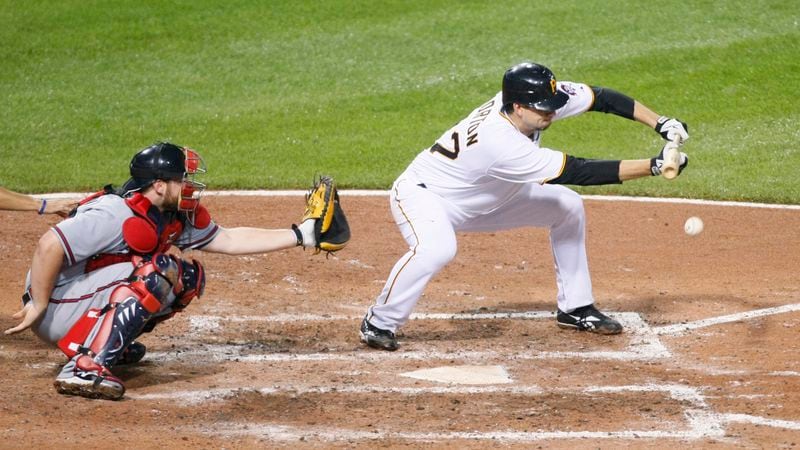 Pittsburgh Pirates starting pitcher Charlie Morton lays down a bunt against the Atlanta Braves Saturday, May 22, 2010, in Pittsburgh. Morton, who rejoined the Braves for the 2021 season, is a career .075 hitter. (Keith Srakocic/AP)