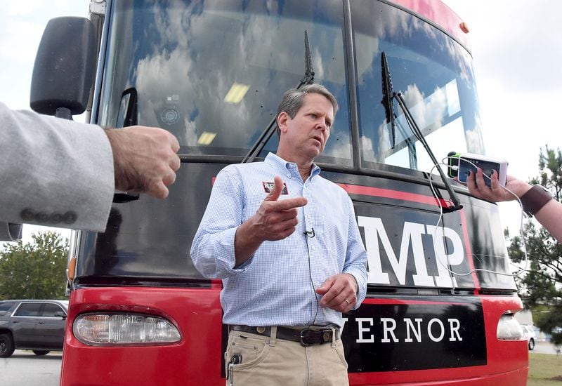 GOP candidate for governor Brian Kemp takes questions from reporters in front of the Kemp campaign bus, after speaking to supporters in Perry. Kemp’s campaign style hasn’t relied on celebrity appearances but plays up his rural roots. (RYON HORNE / RHORNE@AJC.COM)