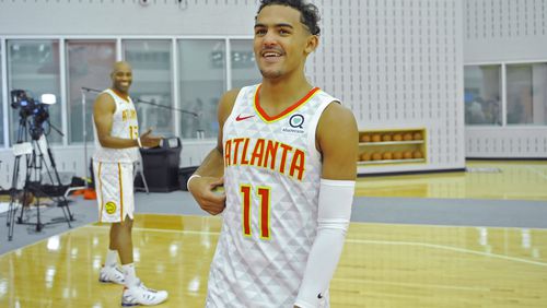 Hawks guard Trae Young smiles as he walks toward reporters after talking with forward Vince Carter (left) during the Atlanta Hawks Media Day Sept. 30, 2019, at Emory Sports Medicine Complex in Atlanta.