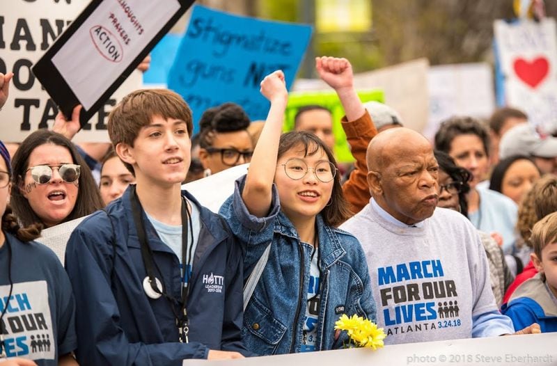 Ethan Asher, left, and Kailen Kim march with Congressman John Lewis at the March For Our Lives event in downtown Atlanta on March 24, 2018. Courtesy of Ethan Asher