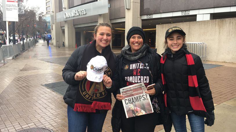 Paula Taylor let her daughters Madison, 16, and Sarah,14, miss school at attend the victory parade for Atlanta United.