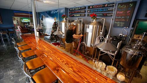 Ron Shea, the owner and brewer at R. Shea Brewing, cleans the fermentor at the brewery Wednesday, Dec. 2, 2015 in Akron, Ohio. (Karen Schiely/Akron Beacon Journal/TNS)