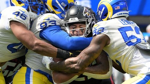 Los Angeles Rams defenders Bobby Wagner (45), Marquise Copeland (93) and Terrell Lewis stop Atlanta Falcons running back Tyler Allgeier in the first quarter at SoFi Stadium Sunday, Sept. 18, 2022, in Inglewood, California. (Wally Skalij/Los Angeles Times/TNS)