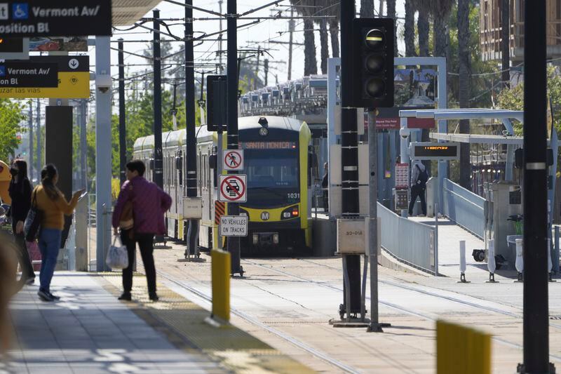 A Metro light rail train resumes service in Los Angeles, Tuesday, April 30, 2024. Officials say multiple people were hurt, and a few seriously, when a Metro light rail train and a University of Southern California shuttle bus collided in downtown Los Angeles. (AP Photo/Damian Dovarganes)
