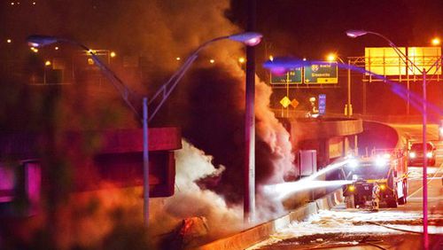 Smoke billows from a section of an overpass that collapsed from a large fire on Interstate 85 in Atlanta, Thursday, March 30, 2017. Witnesses say troopers were telling cars to turn around on the bridge because they were concerned about its integrity. Minutes later, the bridge collapsed. (AP Photo/David Goldman)