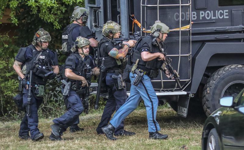 A Cobb County SWAT team negotiated with the man for more than five hours outside the Taylor Apartments on Bellemeade Drive before he surrendered Thursday morning, May 12, 2022, and was taken into custody. (John Spink / John.Spink@ajc.com)

